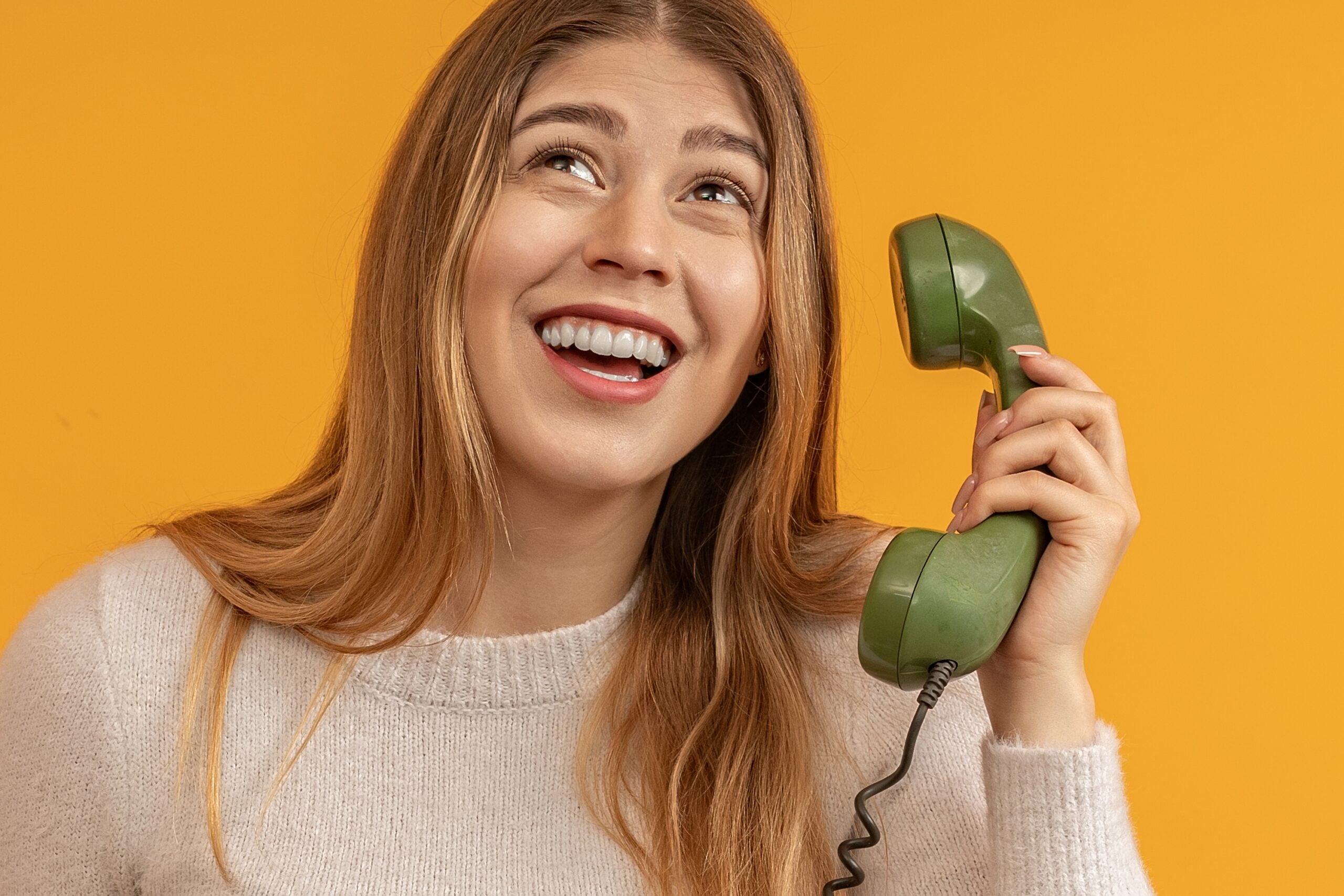 Young woman on an old fashioned phone.