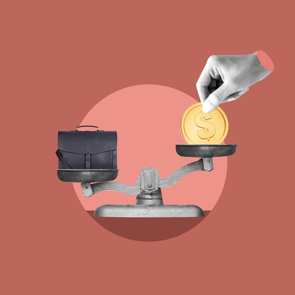 Scale with money and a briefcase on either side.