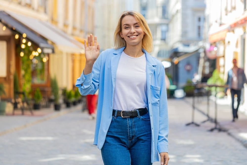 Woman waving goodbye.