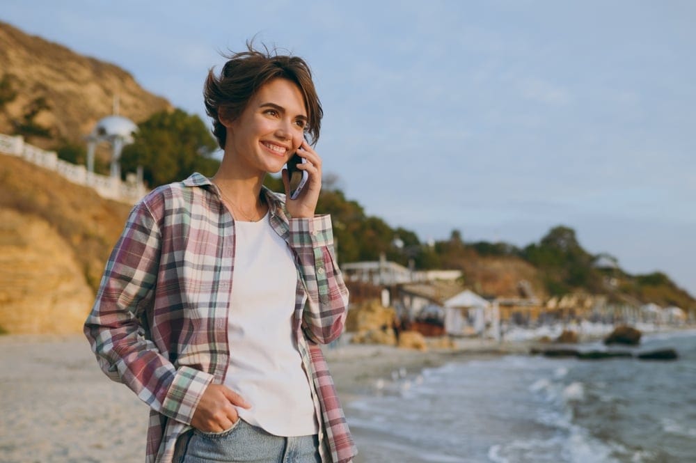 Young woman walking along the beach.