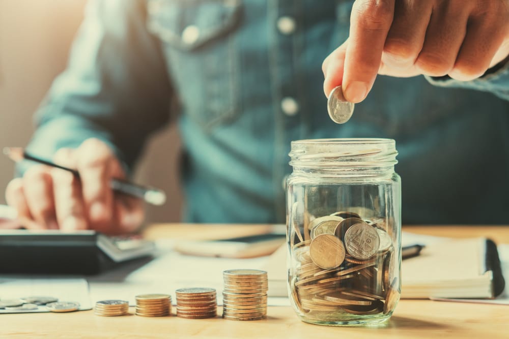 Man filling up a piggybank.