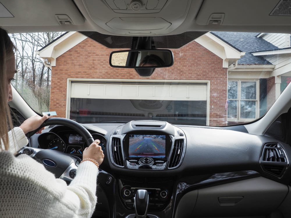 Woman at the wheel of her car.