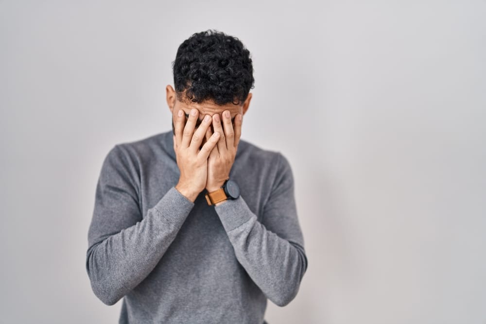 Man with his head in his hands.