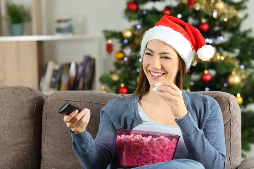 Woman watching TV at Christmas.