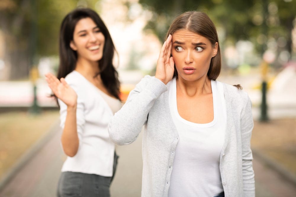 One young woman avoiding her friend.
