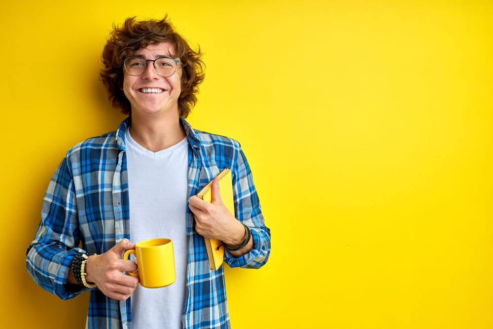 Happy young man drinking coffee.