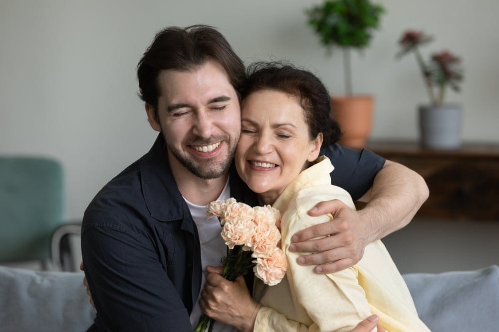 Mother and son embracing.