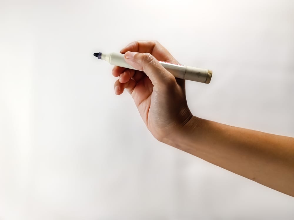 Hand holding a marker.