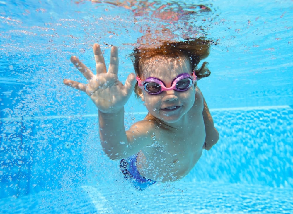 Little boy swimming under water.
