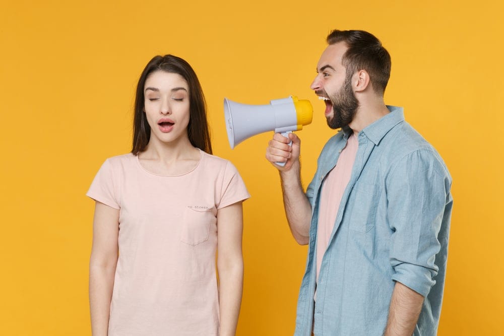 One friend using a bullhorn to get the attention of another.