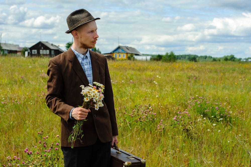 Man carrying a bouquet of flowers.