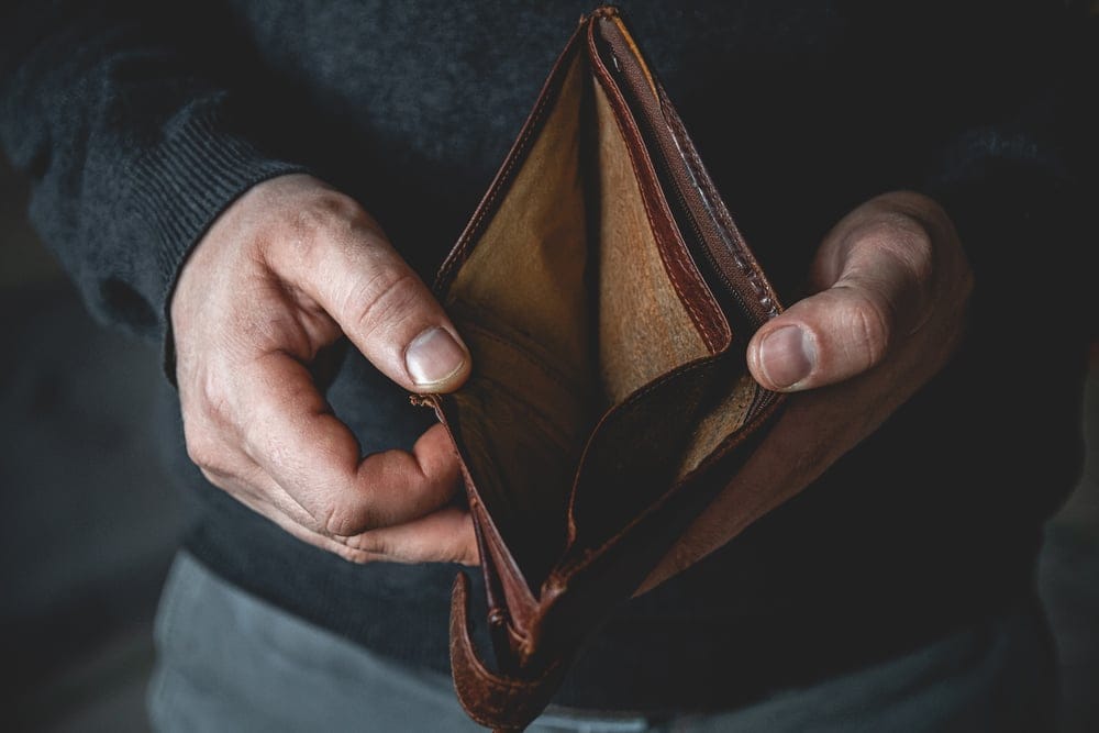 A man holding an empty wallet.