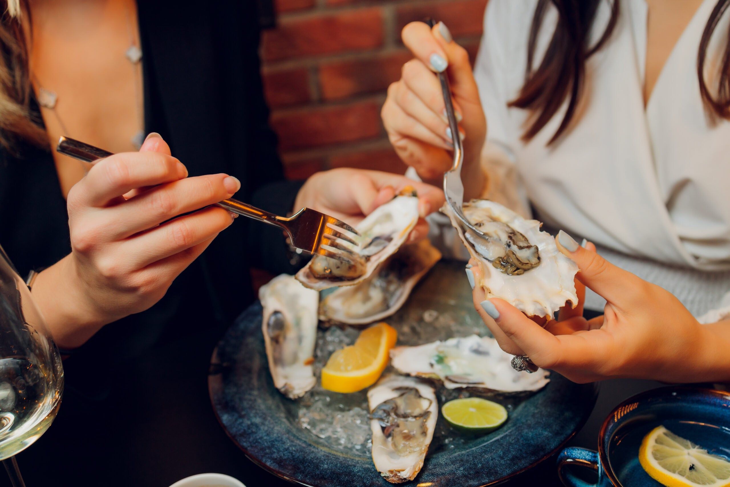 People enjoying oysters at a restaurant.