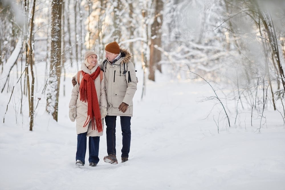 Senior couple walking in the woods.