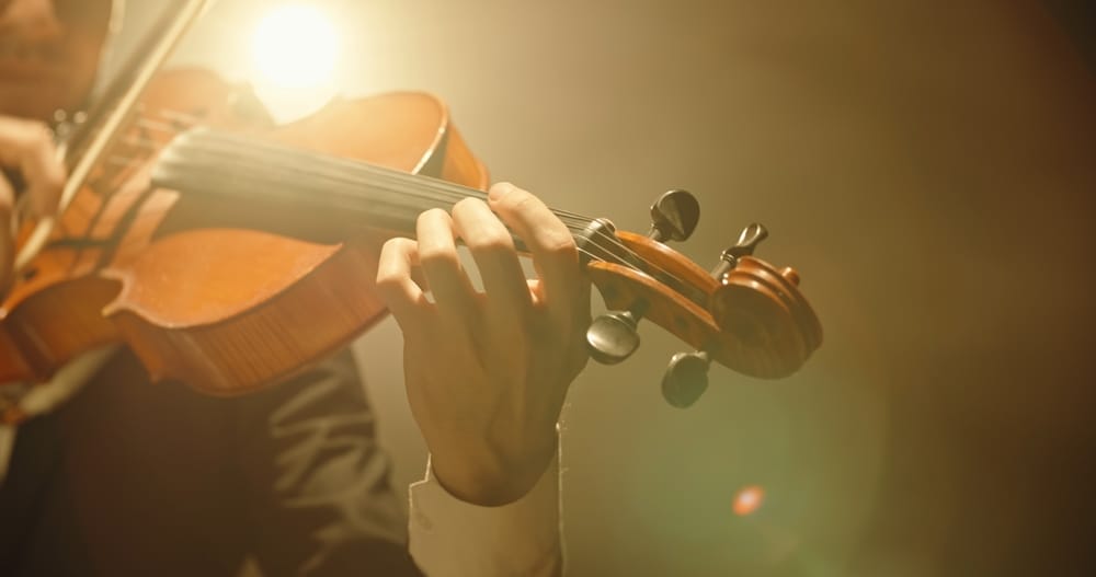Violinist performing on stage.