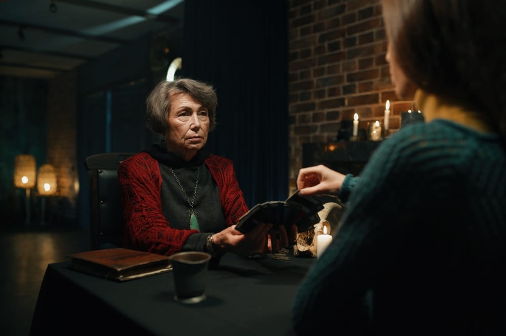 Mature woman predicting future of another.