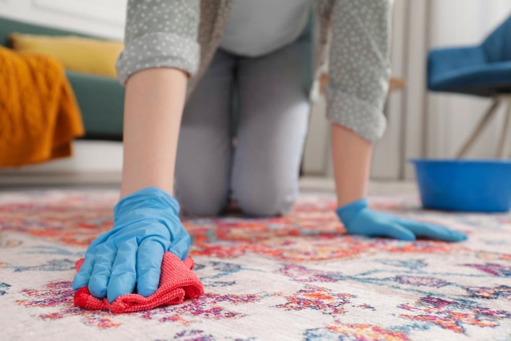 Woman cleaning with rubber gloved.