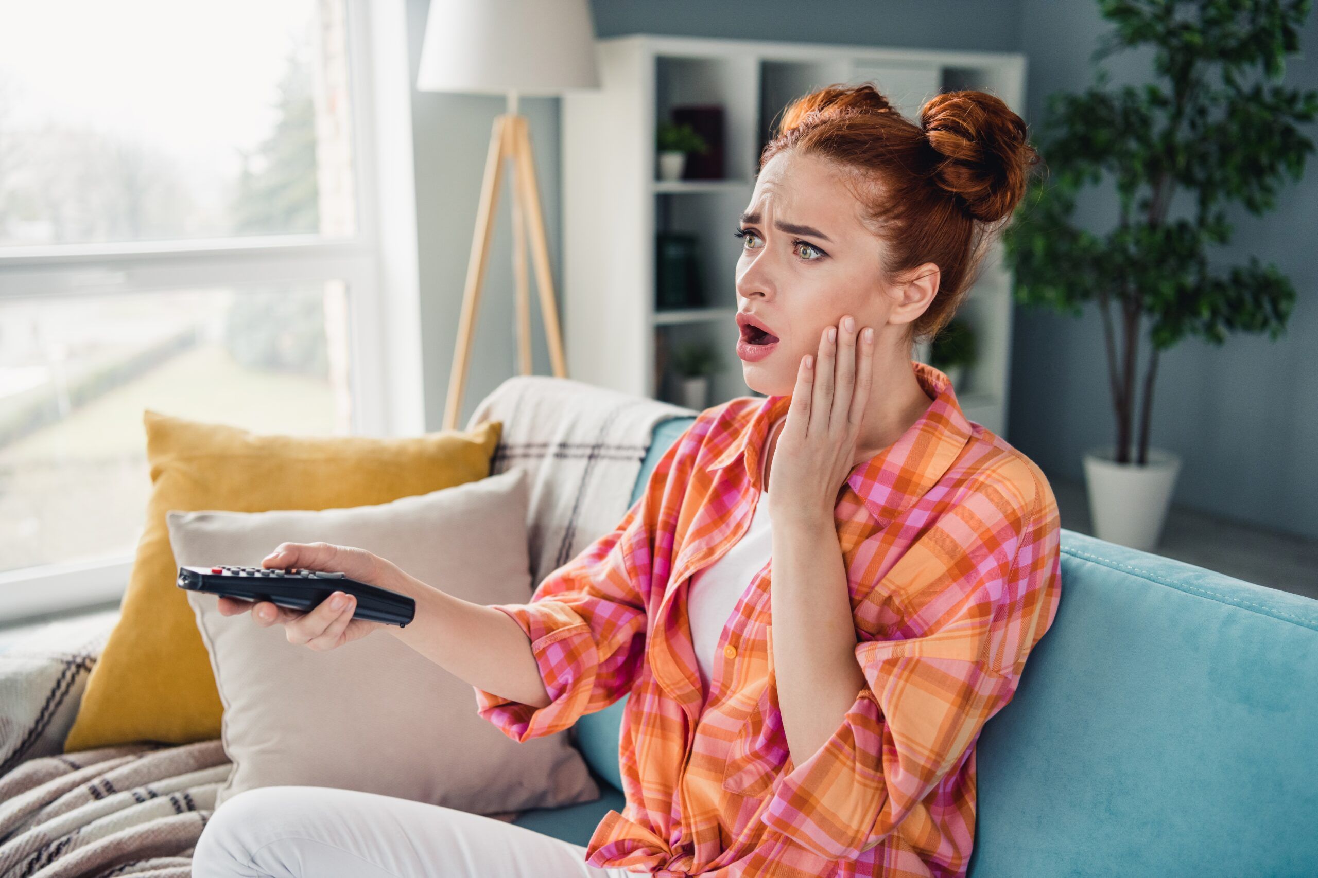 A woman watching TV.