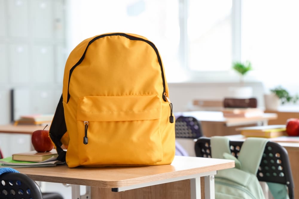 Yellow backpack in a classroom.