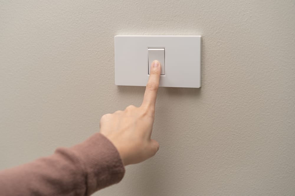 Hand on a lightswitch.