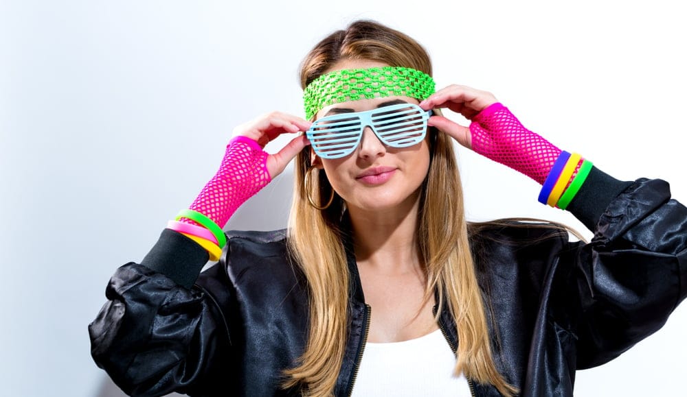 Woman in neon glasses and gloves.