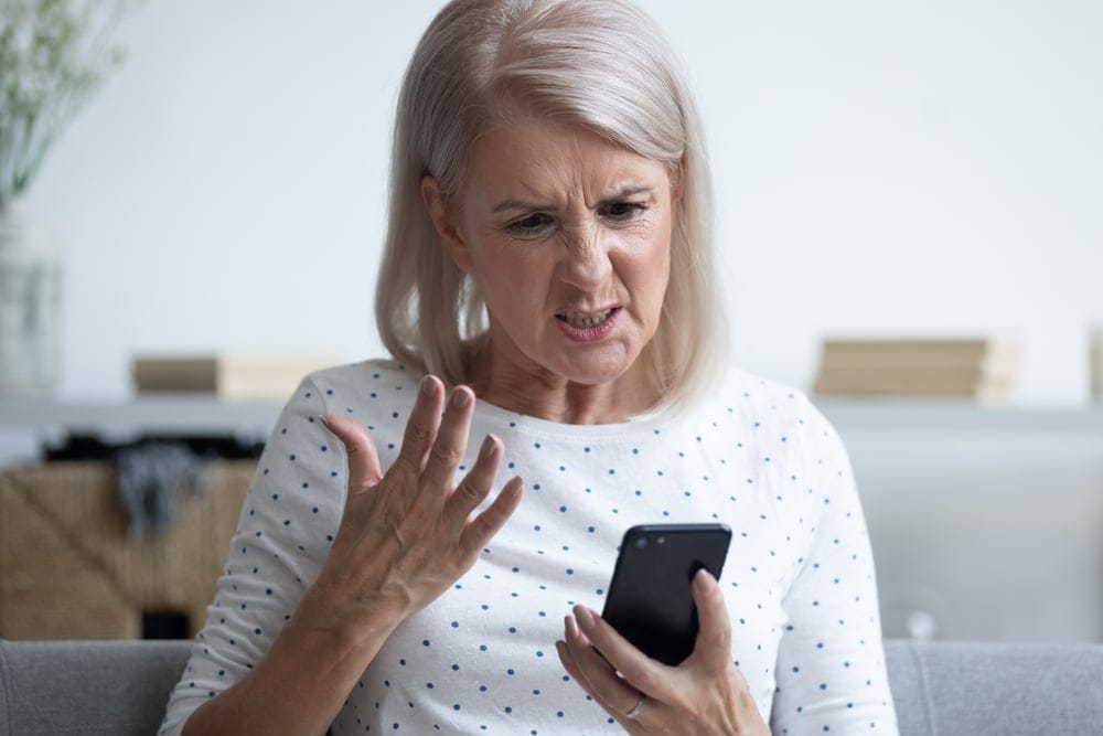 Unhappy middle aged woman on phone.