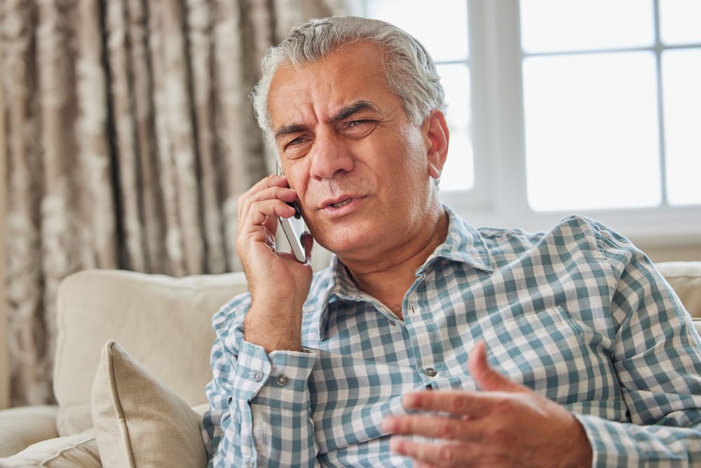 Man on the phone looking serious.