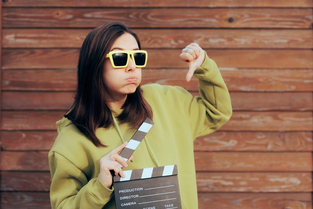 Woman playfully holding a movie prop.