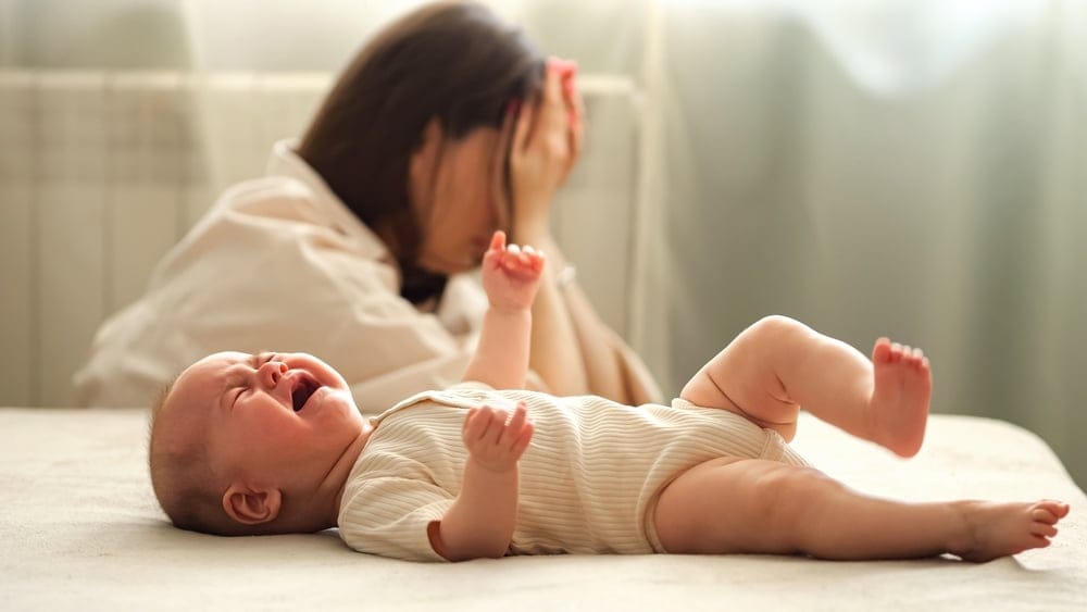 Exhausted new mom with infant.