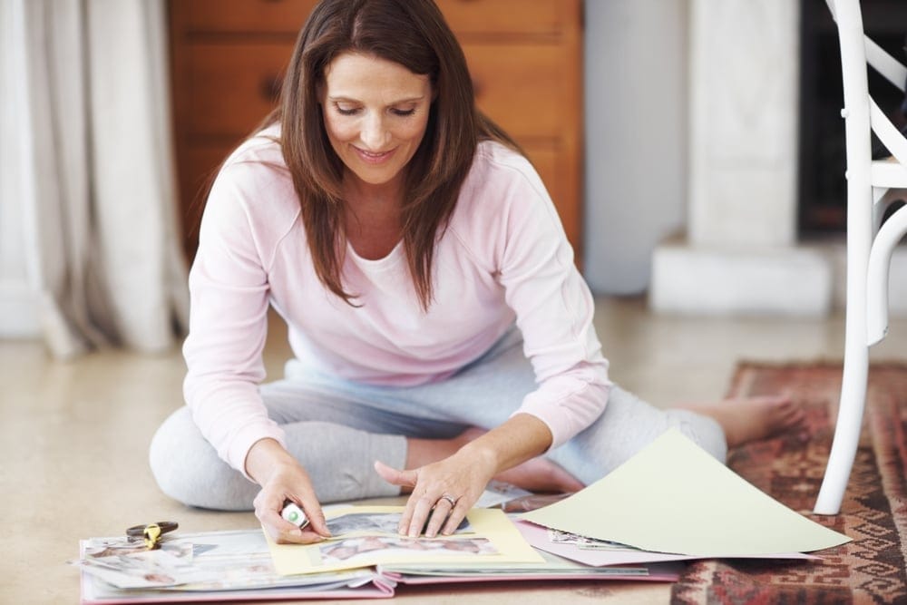 Woman scrapbooking at home.