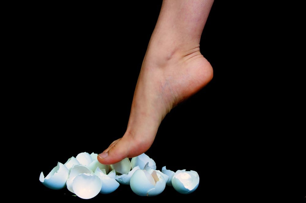 Woman walking on eggshells.