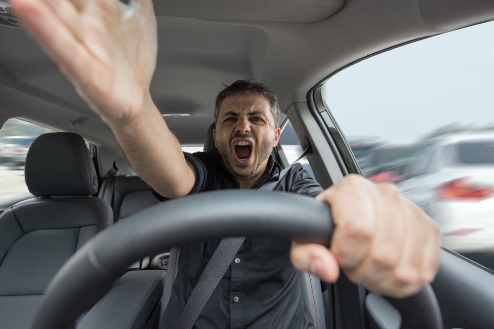 Angry man driving his car.