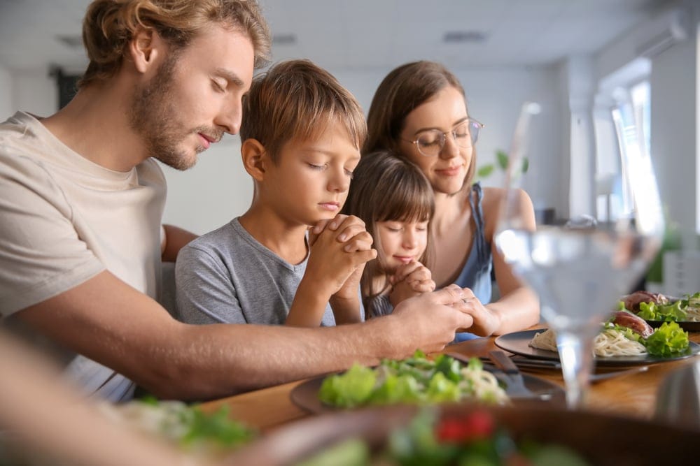 Family praying before dinner.
