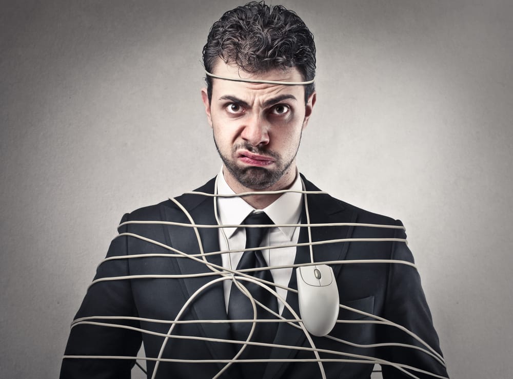 Man tired up in electronic wires.