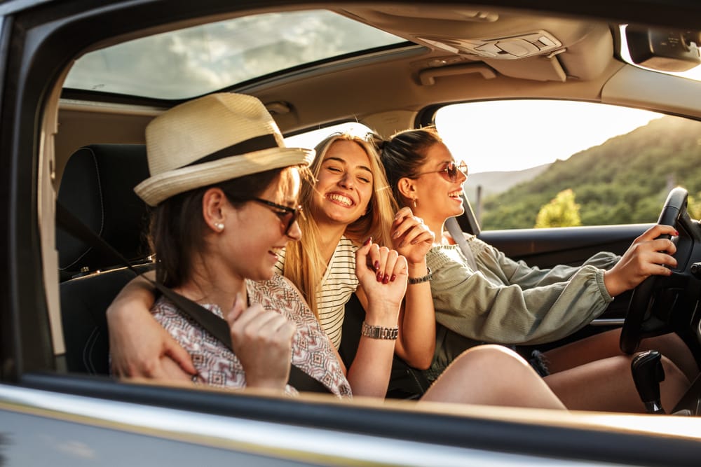 Three female friends laughing.