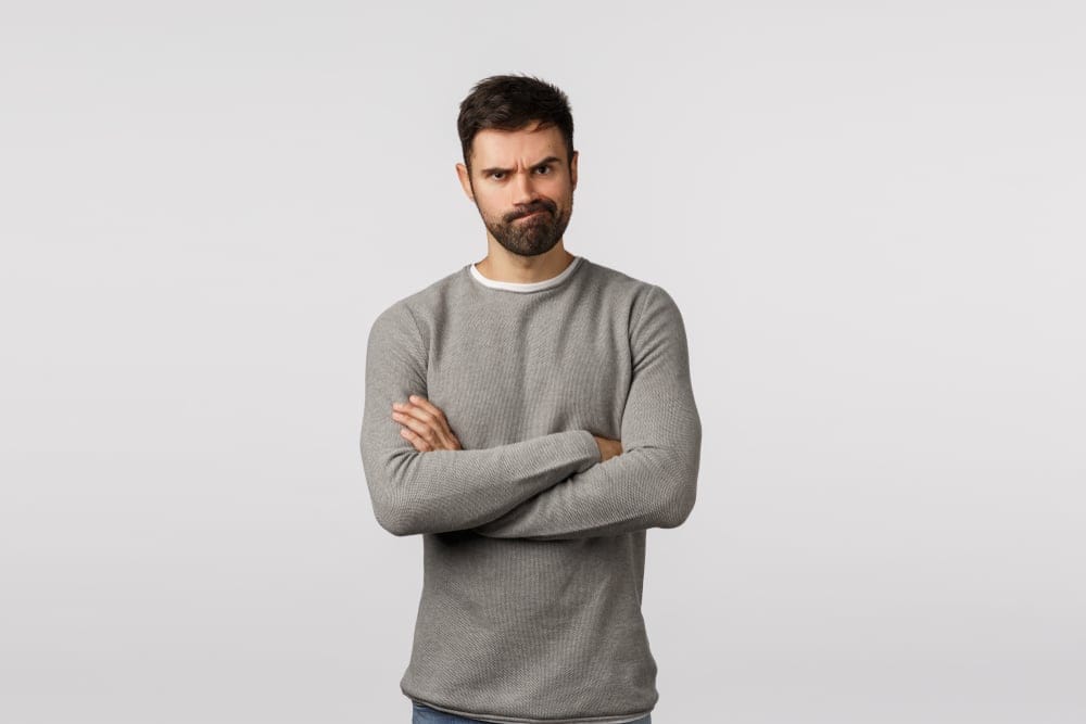 Serious looking man with his arms crossed.