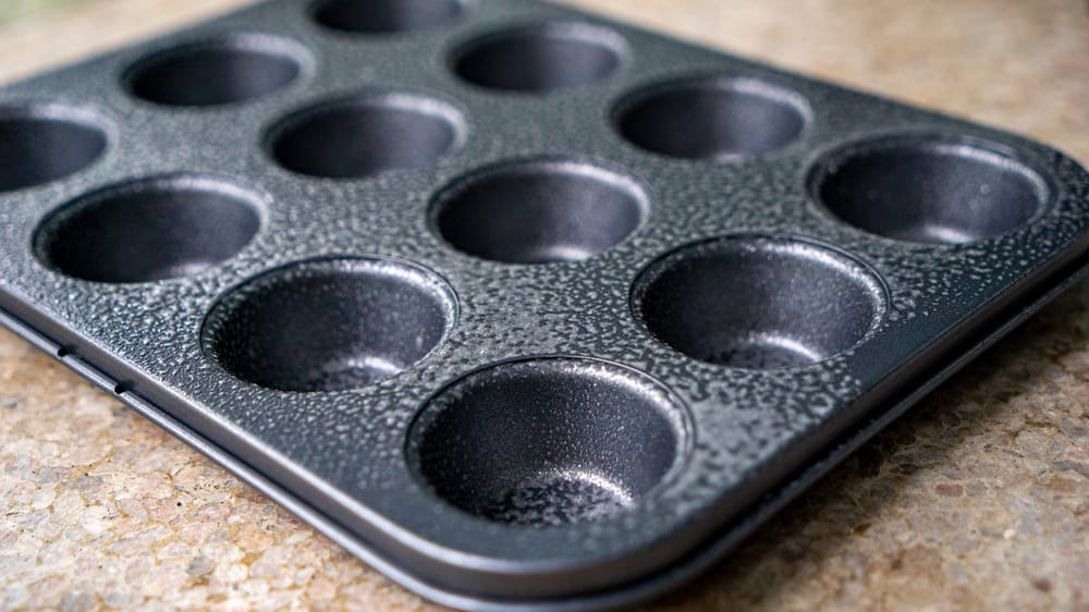 A greased muffin tin.