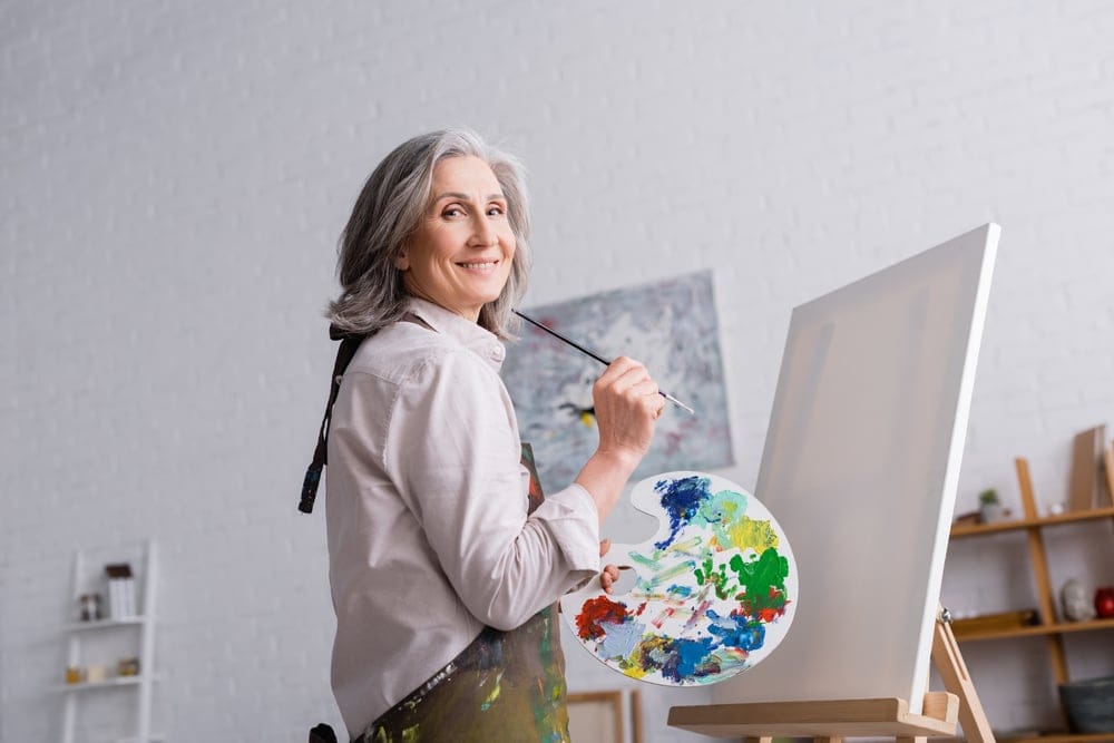 Woman painting with an easel.