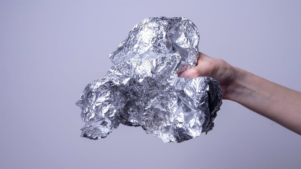 Woman holding aluminum foil.