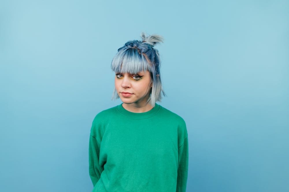 Woman with blue makeup and hair. 