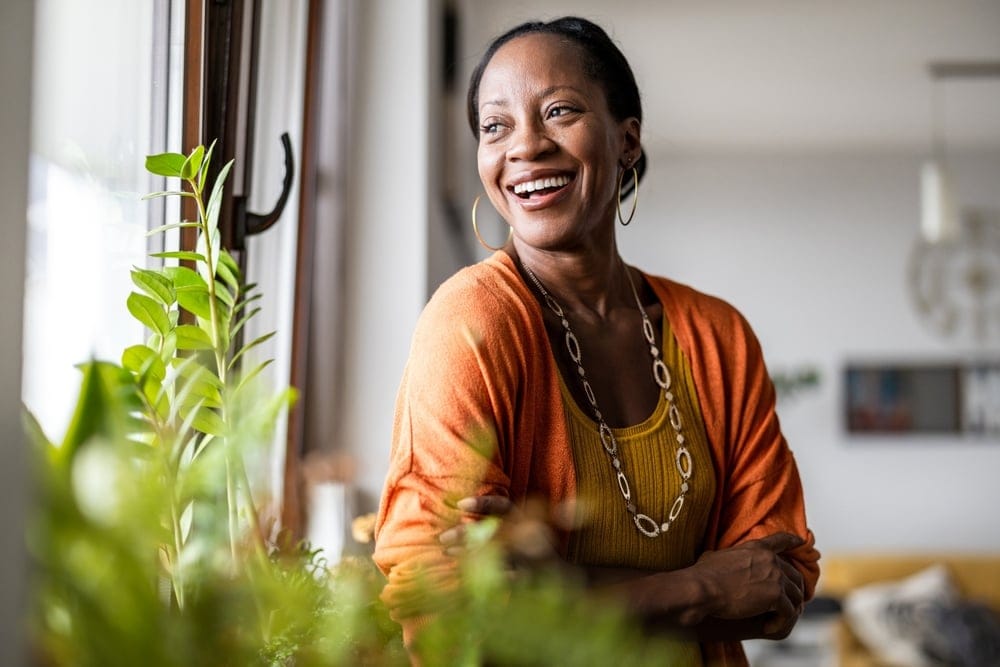 Woman smiling alone at home.