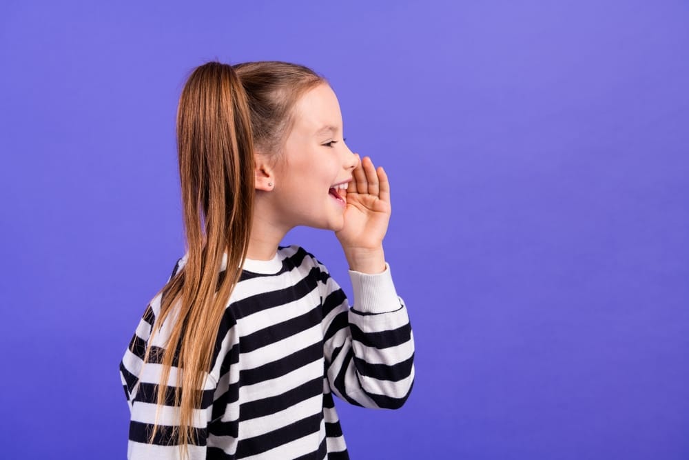 Little girl calling out to someone.