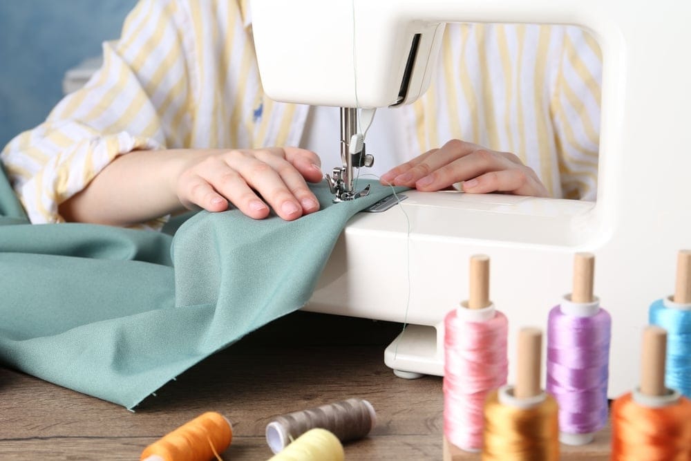 Seamstress on a sewing machine.