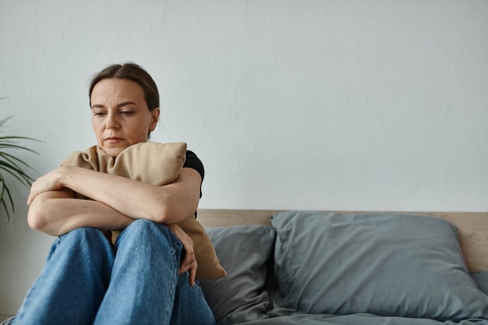 Woman alone at home looking forlorn.
