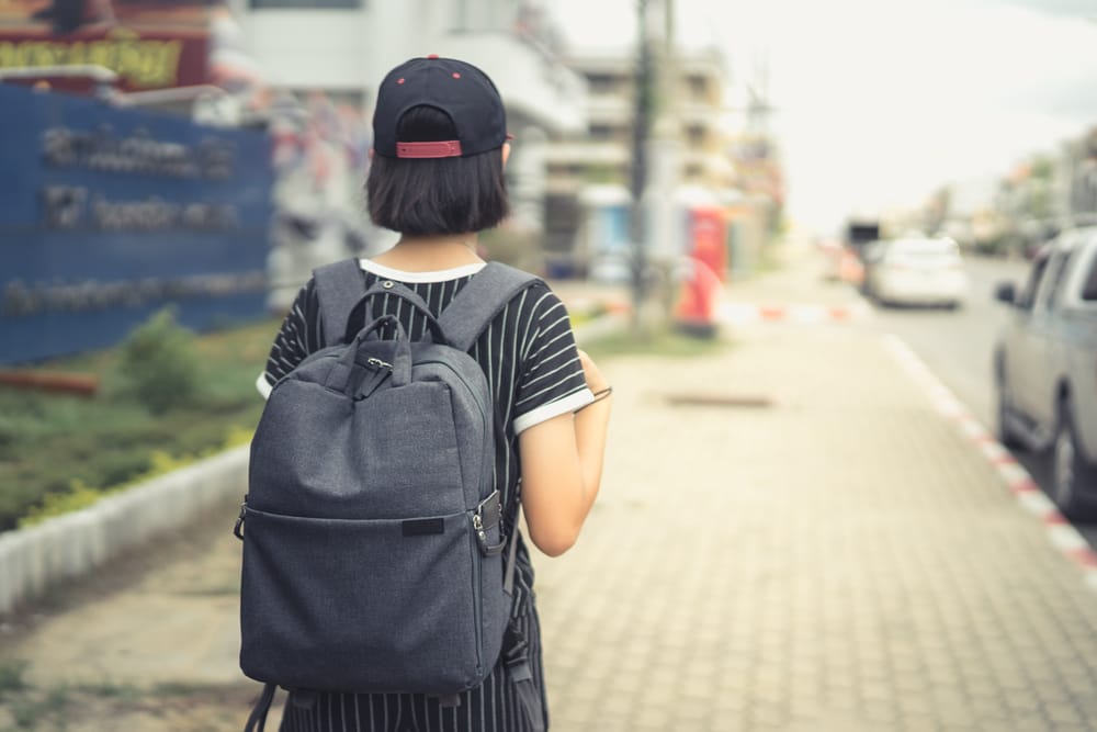 Young person carrying a backpack.