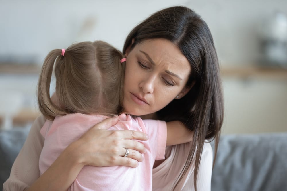 Mother comforting daughter.