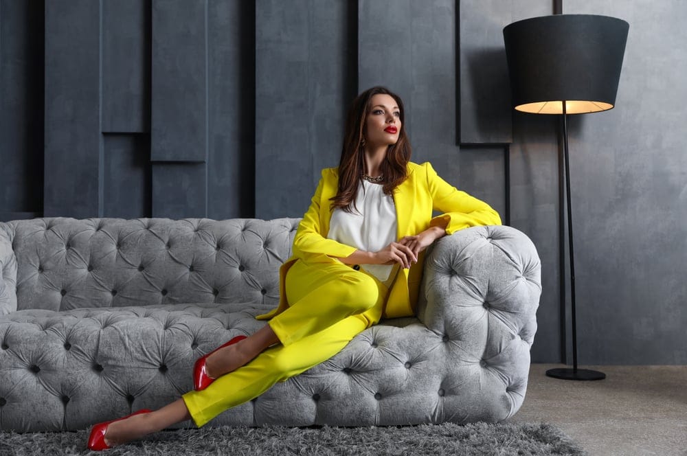 Stylish woman sitting on her sofa.