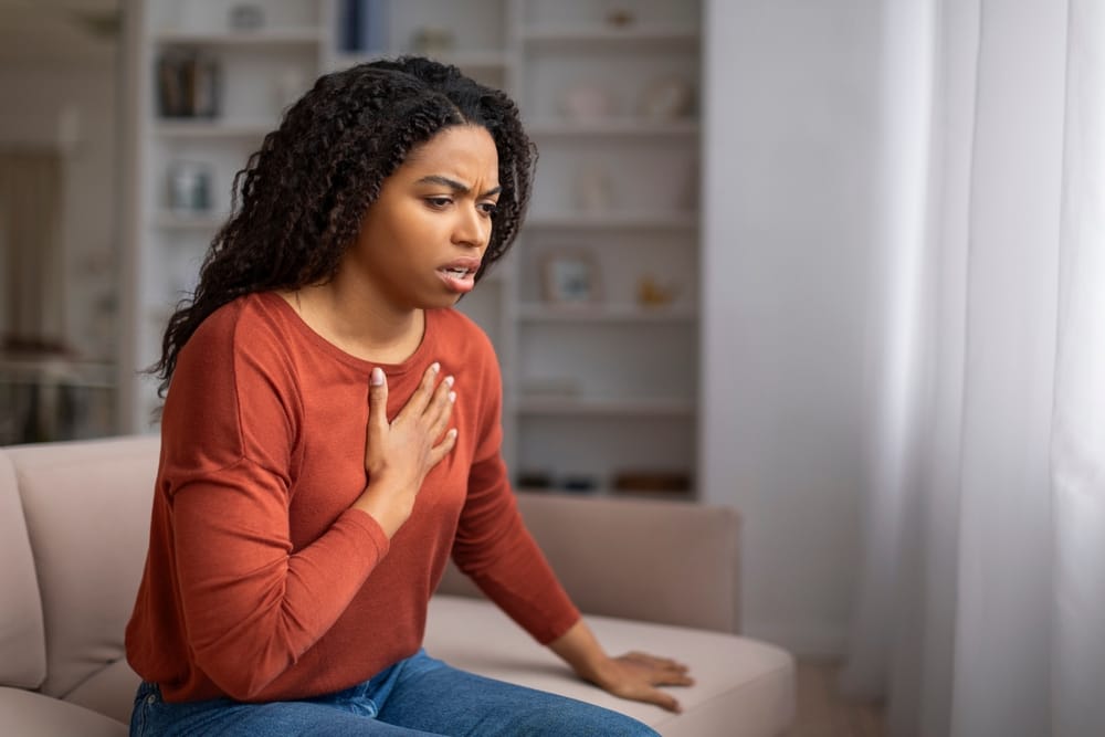 concerned woman holding her chest