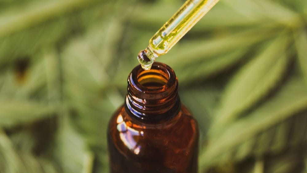 Drops of CBD oil in a bottle.