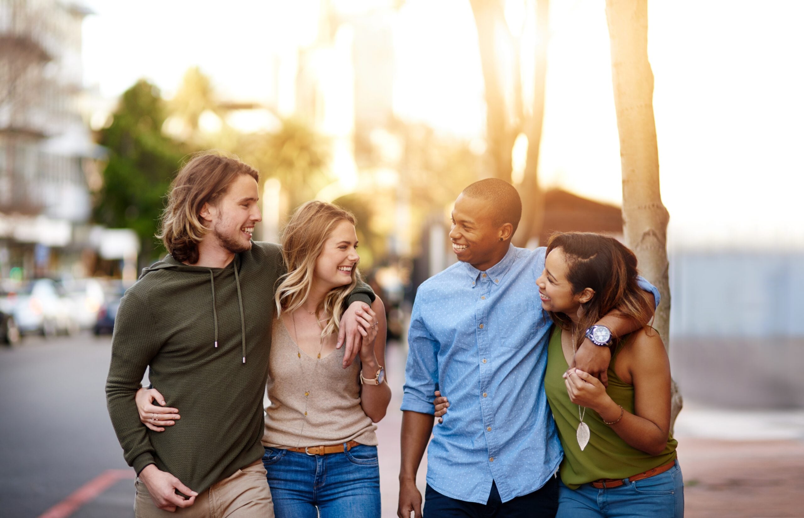 Friends smiling and walking together.